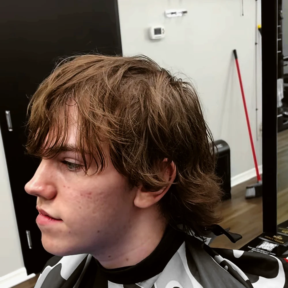 Long, grown-out hair in profile, before the cut
