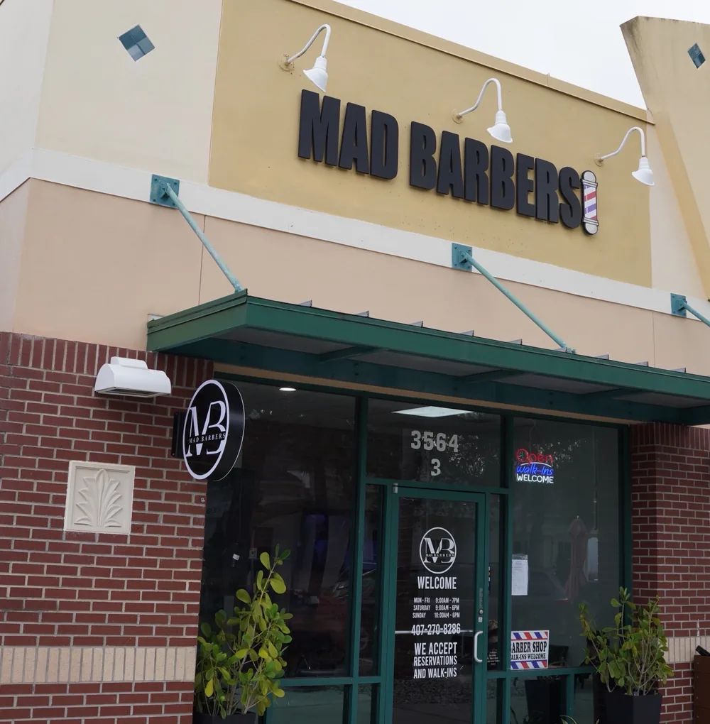 The Mad Barbers storefront at Avalon Park, with the open sign in the window